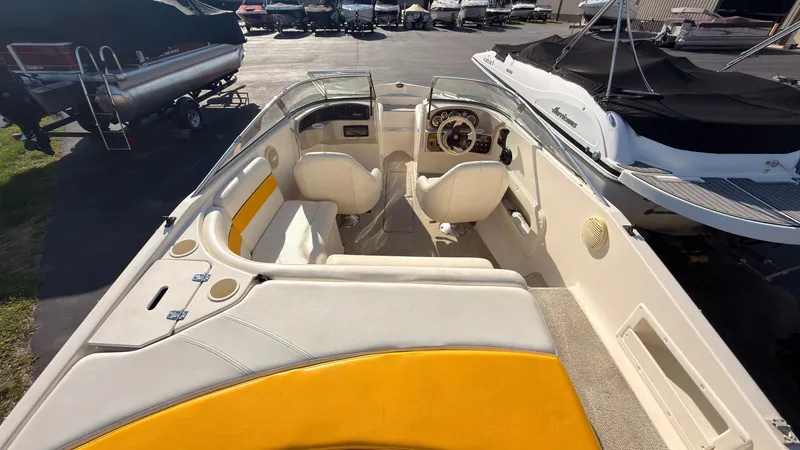 Slide: The Image of The image shows a 2002 Rinker 192 Captiva Bowrider with yellow and white seats in the cockpit area. - 5