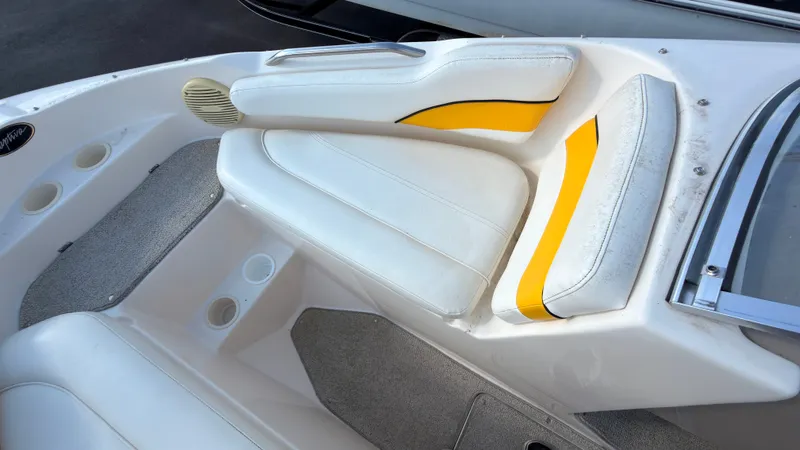 Slide: The Image of The 2002 Rinker 192 Captiva Bowrider features white and yellow upholstery with cup holders. - 33
