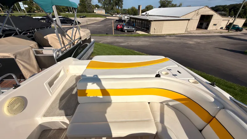 Slide: The Image of The image shows the stern of a Rinker 192 Captiva Bowrider with yellow and white upholstery. - 8