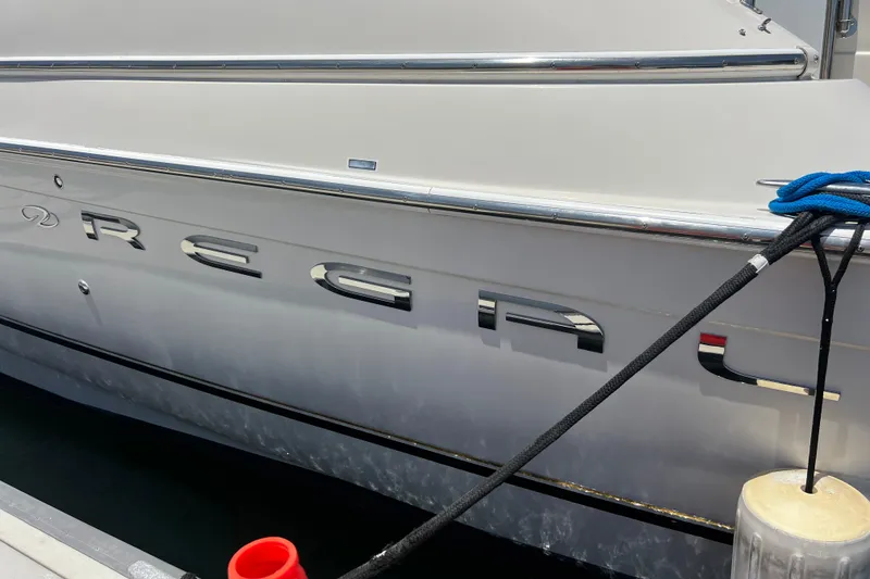 Slide: The Image of 2000 Regal Commodore 4160 yacht docked, showcasing sleek design and branding. - 25