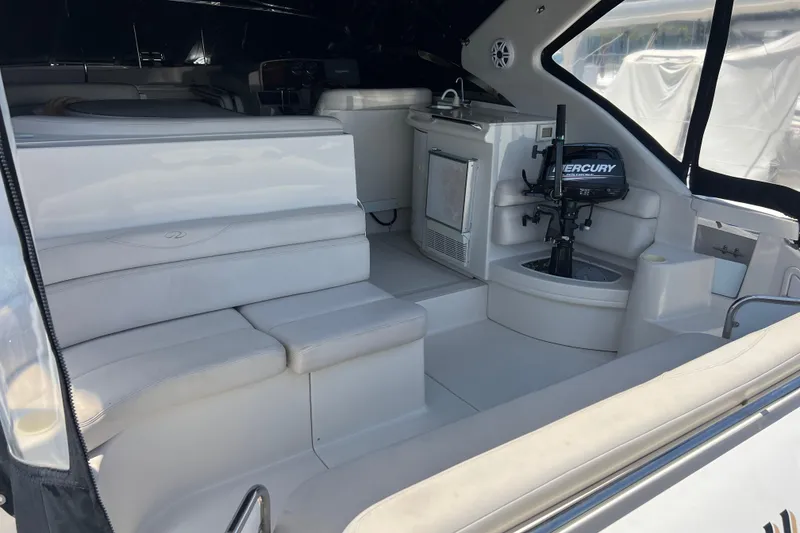 Slide: The Image of Interior of 2000 Regal Commodore 4160 yacht with seating and Mercury engine. - 11