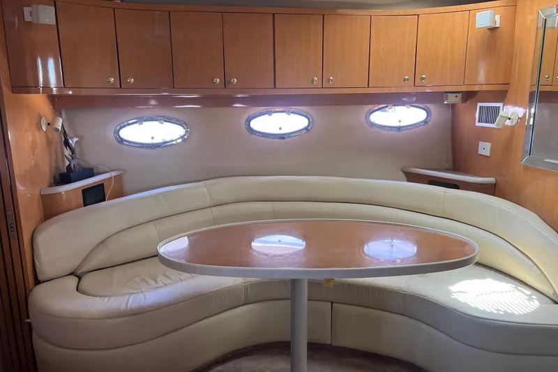 Slide: The Image of Interior of 2000 Regal Commodore 4160 yacht with curved seating and wooden cabinetry. - 19