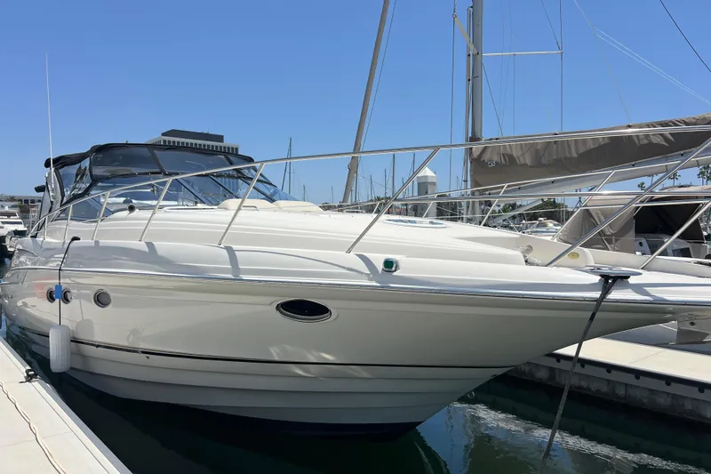 Slide: The Image of 2000 Regal Commodore 4160 yacht docked at marina under clear blue sky. - 2