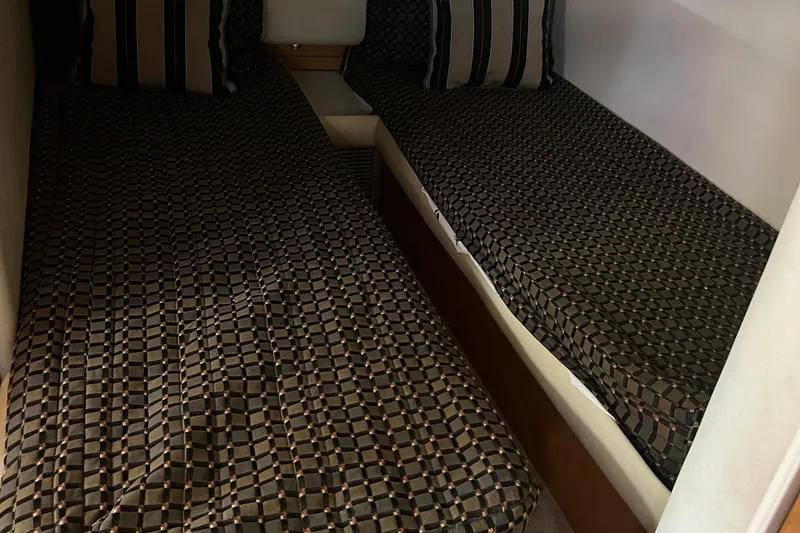 Slide: The Image of Twin beds with patterned covers in a 2000 Regal Commodore 4160 cabin. - 23