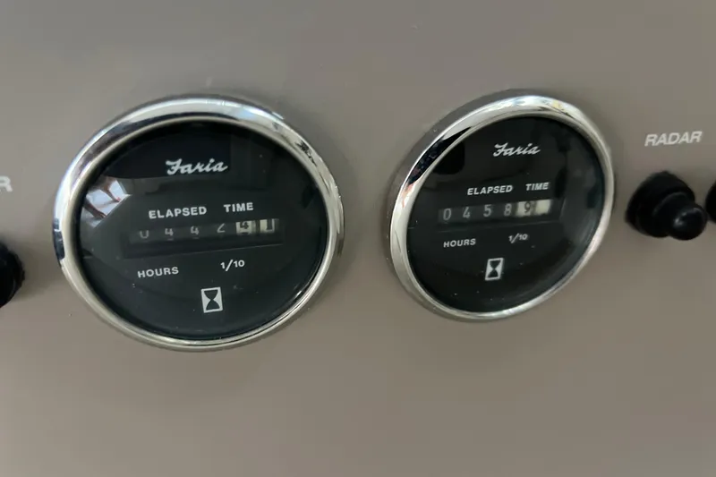 Slide: The Image of Close-up of Faria elapsed time gauges on a 2000 Regal Commodore 4160 boat. - 14