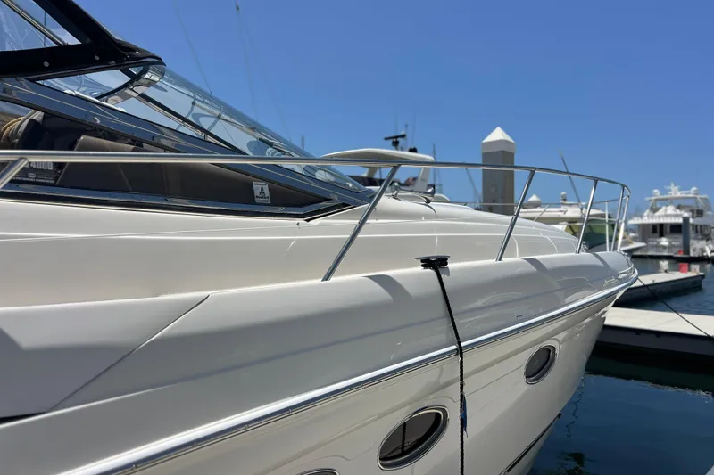 Slide: The Image of 2000 Regal Commodore 4160 yacht docked at marina under clear blue sky. - 4