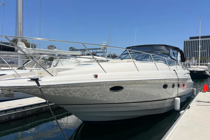 The Image of 2000 Regal Commodore 4160 yacht docked at marina under clear blue sky. - 0