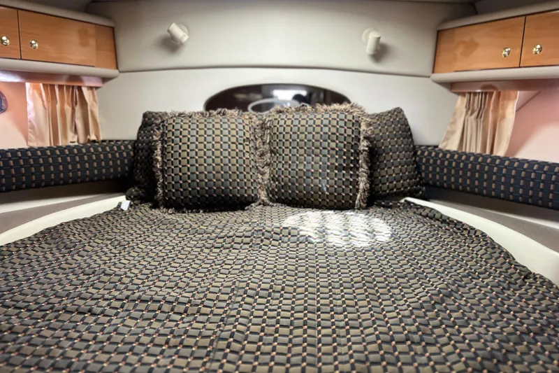 Slide: The Image of Interior cabin of 2000 Regal Commodore 4160 yacht with patterned bedding and cushions. - 21