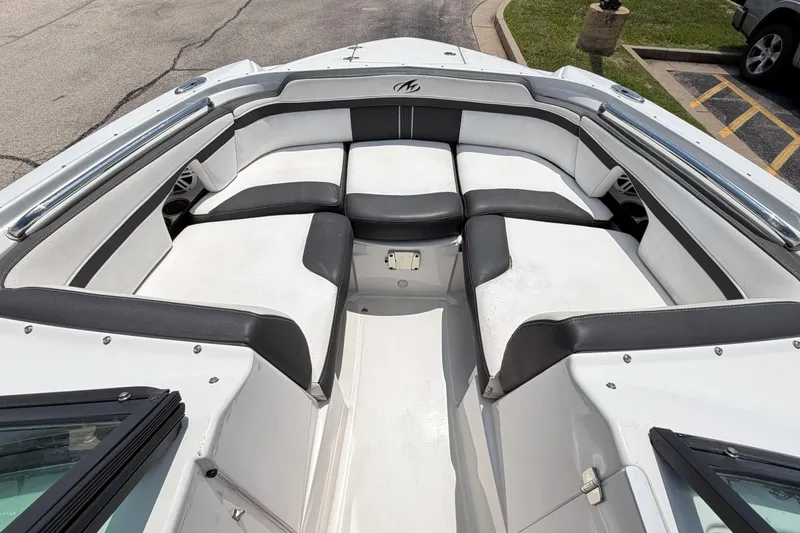 Slide: The Image of 2024 Monterey M4 boat interior with white and black seating, docked in a parking area. - 20