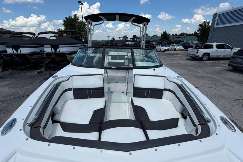 Slide: The Image of 2024 Monterey M4 boat with spacious seating, parked outdoors under a clear sky. - 36
