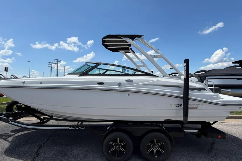 Slide: The Image of 2024 Monterey M4 boat on trailer under blue sky, showcasing sleek design and modern features. - 39