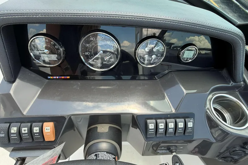 Slide: The Image of Dashboard of a 2024 Monterey M4 boat with gauges and control switches. - 12