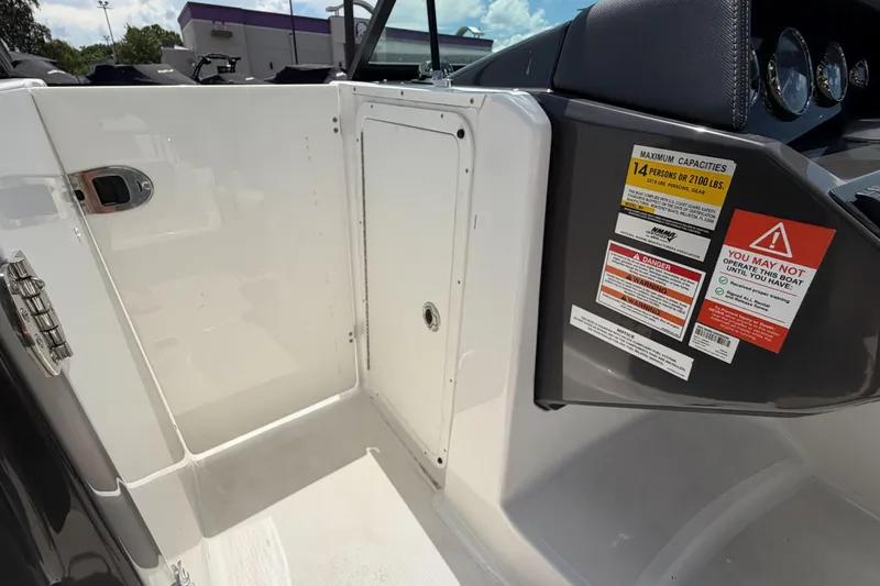 Slide: The Image of 2024 Monterey M4 boat interior with capacity warning labels and storage compartment. - 19