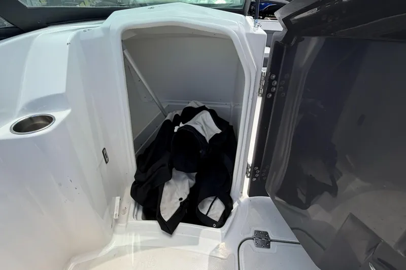 Slide: The Image of 2024 Monterey M4 boat storage compartment with black and white jackets inside. - 8