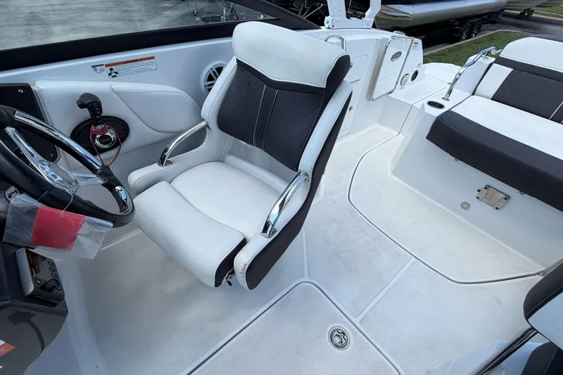 Slide: The Image of 2024 Monterey M4 boat interior with sleek white and black seating and modern steering controls. - 28
