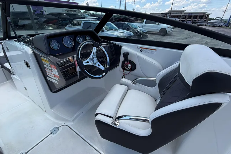 Slide: The Image of 2024 Monterey M4 boat interior with steering wheel, dashboard, and captain's seat. - 25