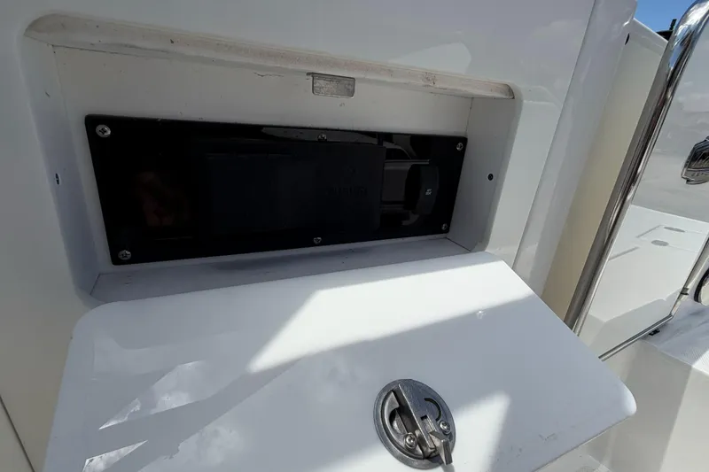 Slide: The Image of 2024 Monterey M4 boat compartment with open hatch and latch detail. - 17