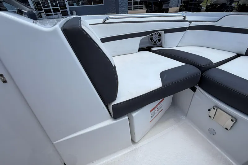 Slide: The Image of 2024 Monterey M4 boat interior with cushioned seating and storage compartment. - 23