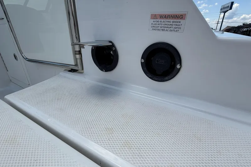 Slide: The Image of 2024 Monterey M4 boat deck with warning label and electrical outlet. - 5