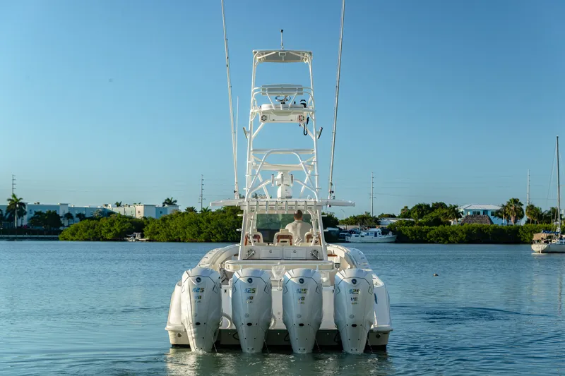 Slide: The Image of 2018 HCB 53 Suenos RXV boat with multiple outboard engines on calm water. - 11