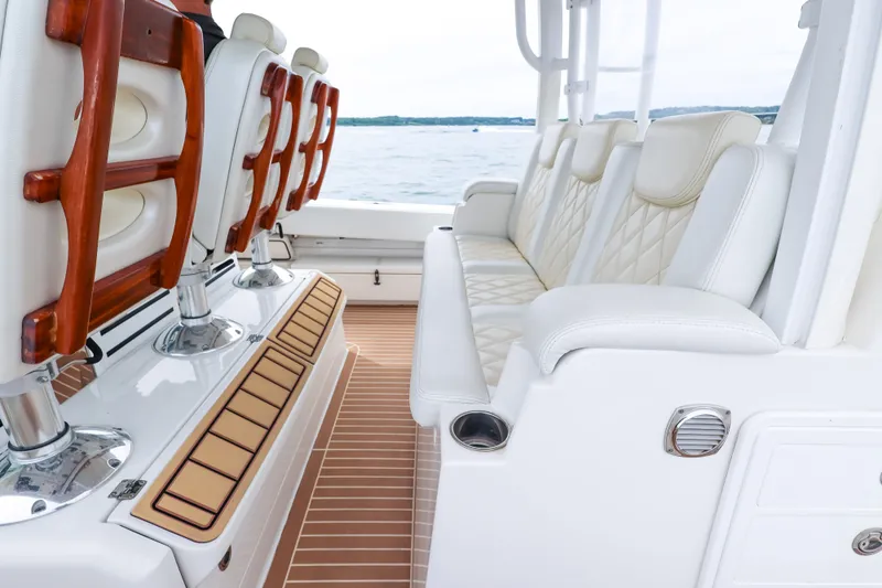 Slide: The Image of Luxurious seating on 2018 HCB 53 Suenos boat, featuring elegant white upholstery and wooden accents. - 33