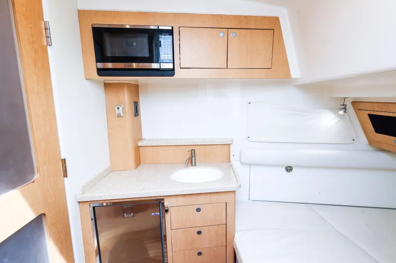 Slide: The Image of Interior of 2018 HCB 53 Suenos yacht featuring kitchenette with microwave and sink. - 37
