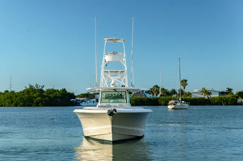 Slide: The Image of 2018 HCB 53 Suenos RXV boat on calm water, clear sky background. - 2