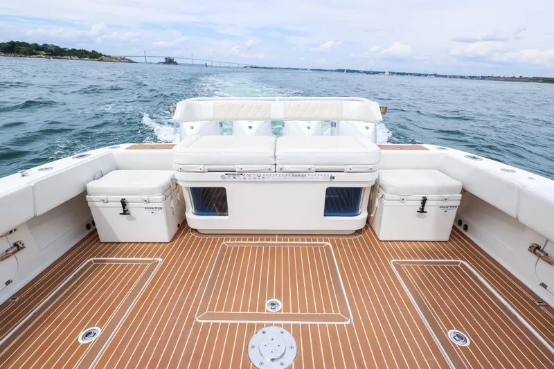 Slide: The Image of 2018 HCB 53 Suenos boat deck with seating and coolers on open water. - 15