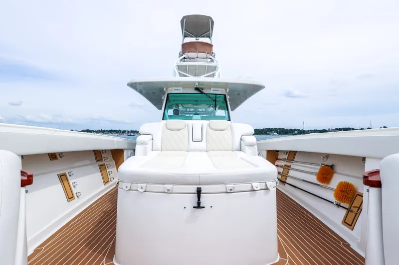 Slide: The Image of 2018 HCB 53 Suenos luxury boat interior with white seating and wooden deck. - 54