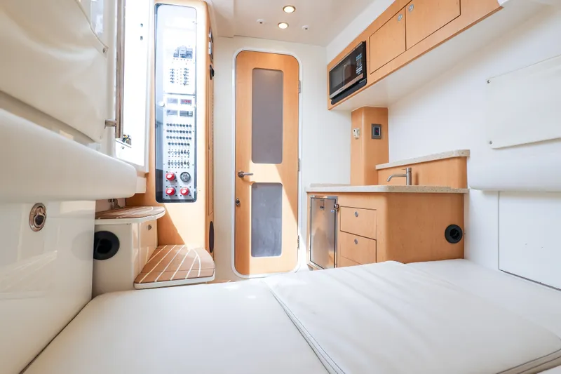 Slide: The Image of Interior of 2018 HCB 53 Suenos yacht featuring modern kitchenette and control panel. - 39