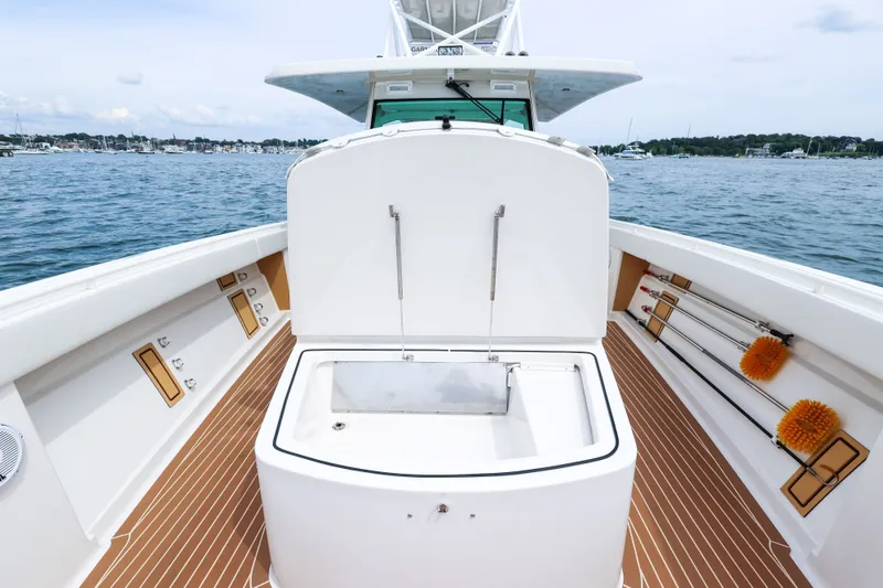 Slide: The Image of 2018 HCB 53 Suenos boat deck with open storage compartment on the water. - 56
