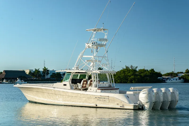Slide: The Image of 2018 HCB 53 Suenos RXV boat with multiple outboard engines on calm water. - 8