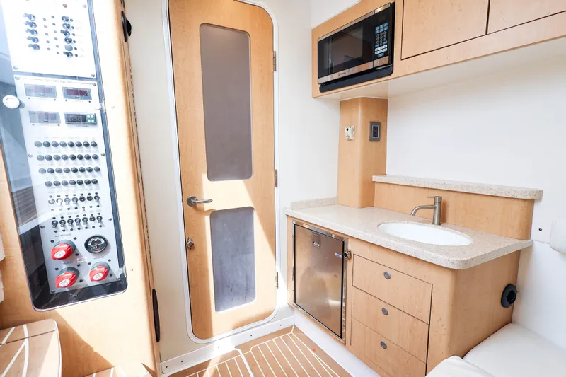 Slide: The Image of Interior of 2018 HCB 53 Suenos yacht featuring kitchenette and control panel. - 38