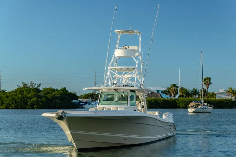 Slide: The Image of 2018 HCB 53 Suenos RXV boat cruising on calm water with clear blue sky. - 3