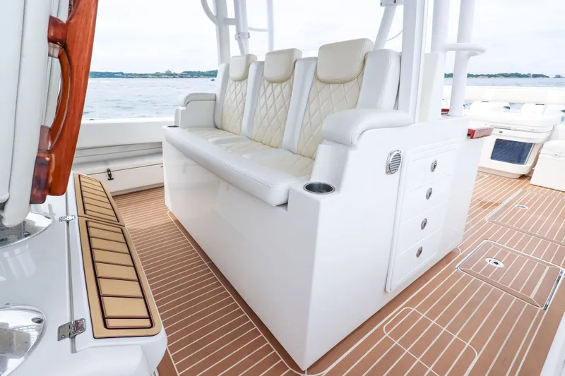 Slide: The Image of Luxurious seating on 2018 HCB 53 Suenos boat with elegant white upholstery and wooden accents. - 34