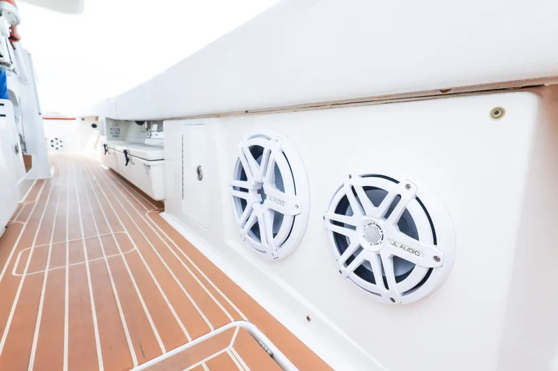 Slide: The Image of 2018 HCB 53 Suenos boat deck with JL Audio speakers, featuring sleek design and wood-like flooring. - 59