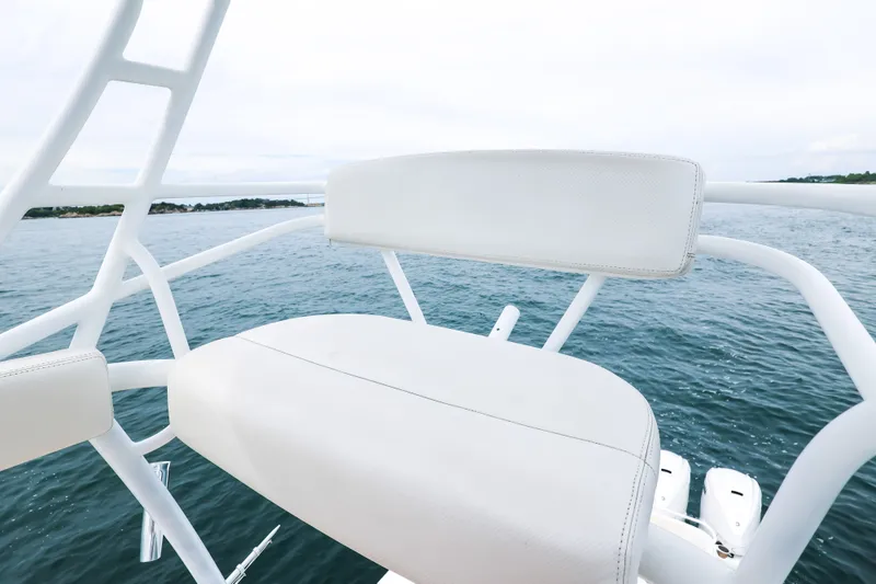 Slide: The Image of White seating on 2018 HCB 53 Suenos boat overlooking ocean waters. - 64