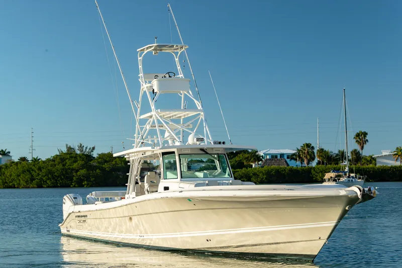 Slide: The Image of 2018 HCB 53 Suenos RXV boat on calm water, clear sky background. - 1