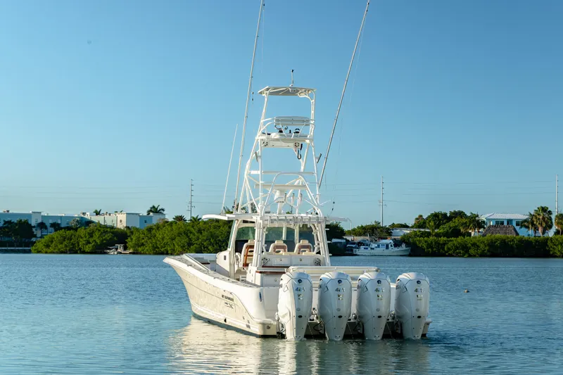Slide: The Image of 2018 HCB 53 Suenos RXV boat with multiple engines on calm water. - 10
