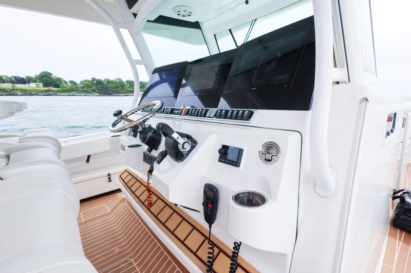 Slide: The Image of 2018 HCB 53 Suenos boat helm with advanced navigation controls and sleek design. - 27