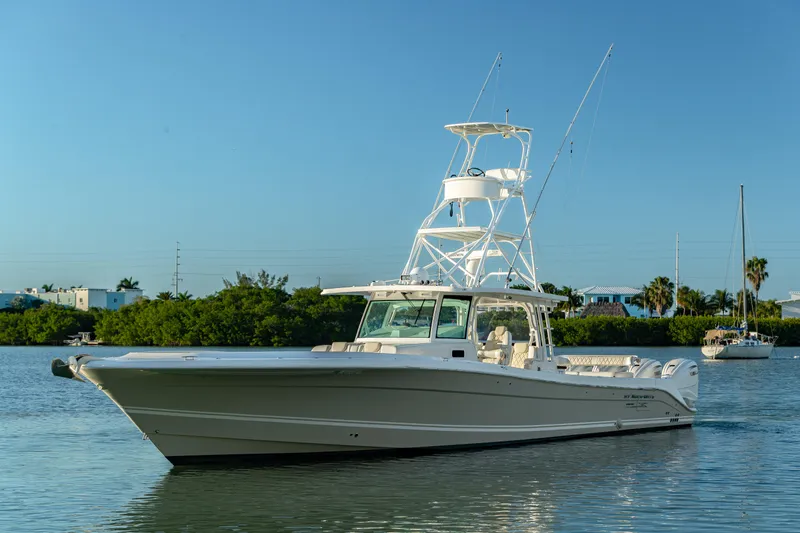 Slide: The Image of 2018 HCB 53 Suenos RXV boat on calm water, clear sky background. - 4
