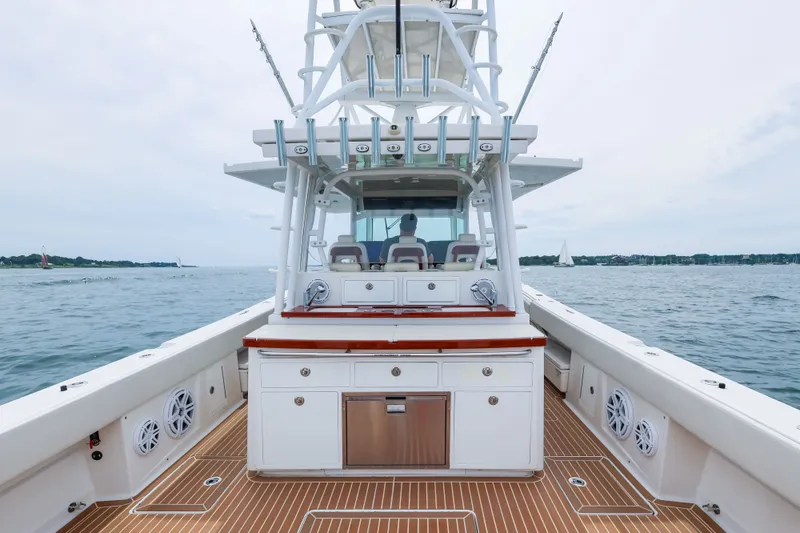 Slide: The Image of 2018 HCB 53 Suenos boat on water, featuring spacious deck and modern design. - 21