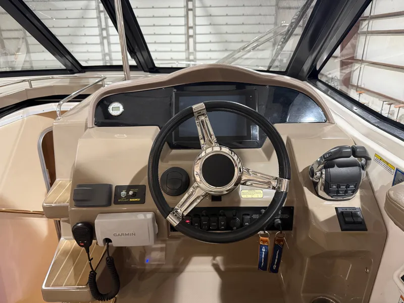 Slide: The Image of The cockpit of the 2018 Regal 35 Sport Coupe features a modern helm and Garmin equipment. - 25
