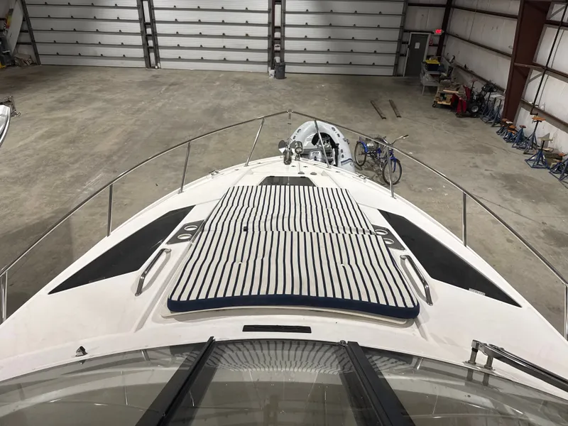 Slide: The Image of The image shows the foredeck of a 2018 Regal 35 Sport Coupe in a storage facility. - 6