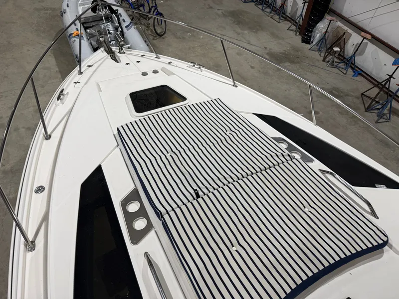 Slide: The Image of The image shows the deck of a 2018 Regal 35 Sport Coupe with striped cushions. - 5