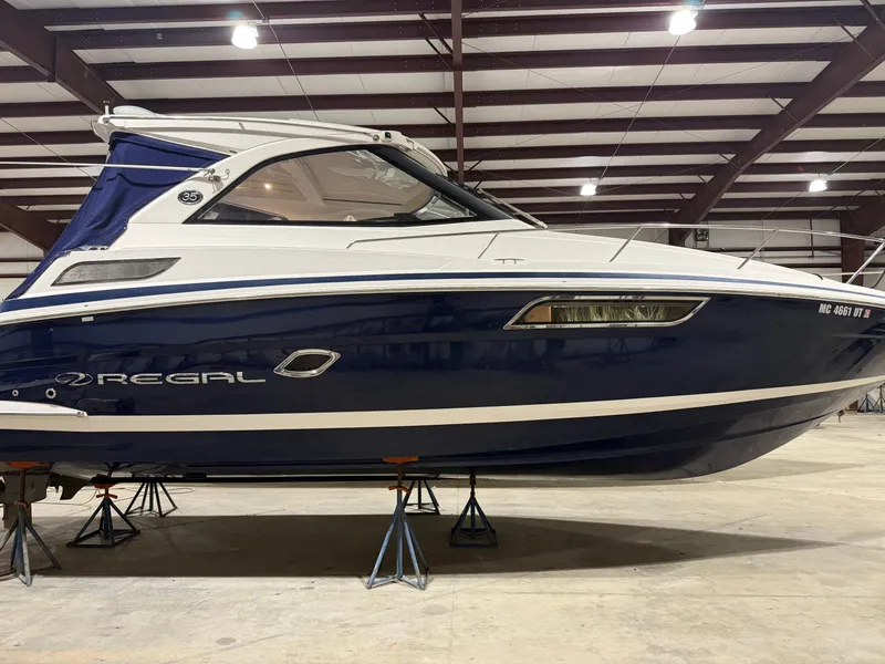 Slide: The Image of A 2018 Regal 35 Sport Coupe is on stands in a warehouse. - 8