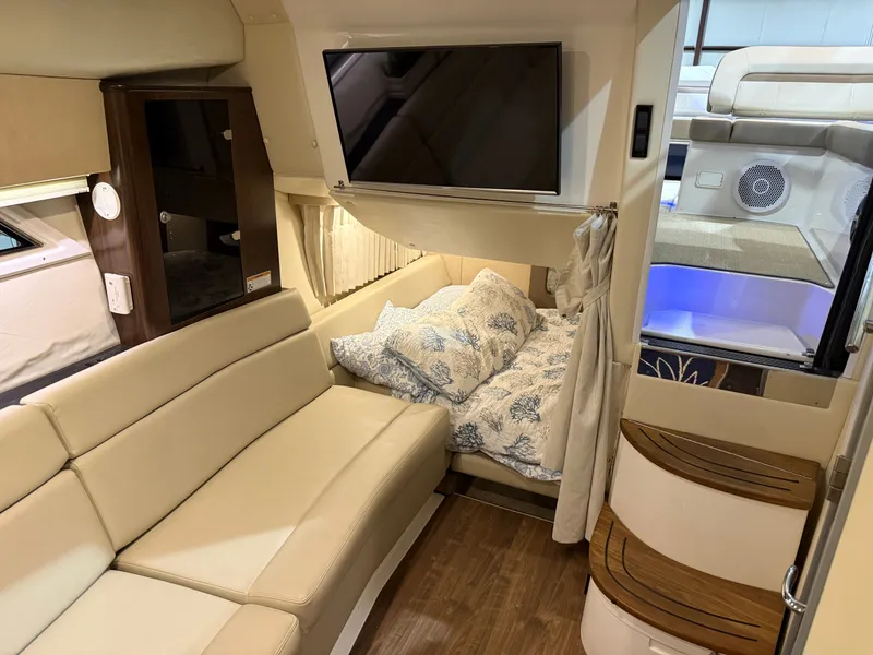 Slide: The Image of Interior of a 2018 Regal 35 Sport Coupe with beige sofa and TV. - 34