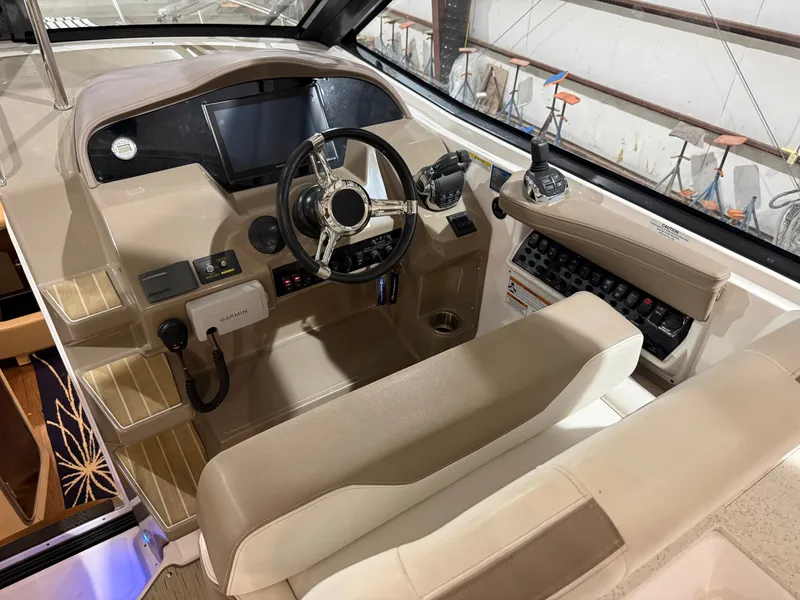 Slide: The Image of The cockpit of a 2018 Regal 35 Sport Coupe with modern steering and electronics. - 2