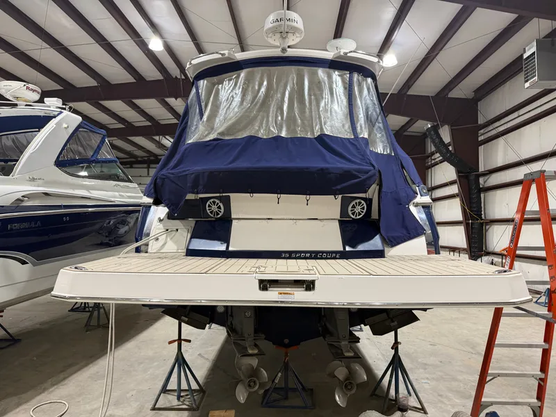 Slide: The Image of A 2018 Regal 35 Sport Coupe is on stands in a storage facility. - 10