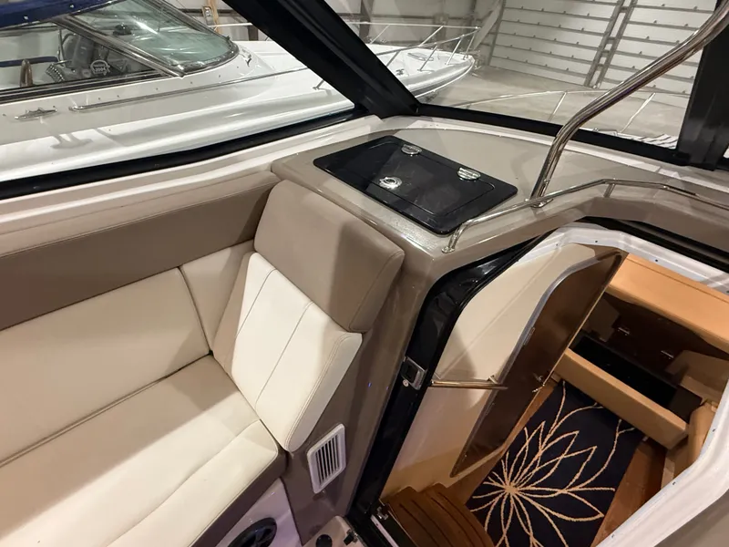 Slide: The Image of Interior of a 2018 Regal 35 Sport Coupe with beige seating area and carpet. - 31
